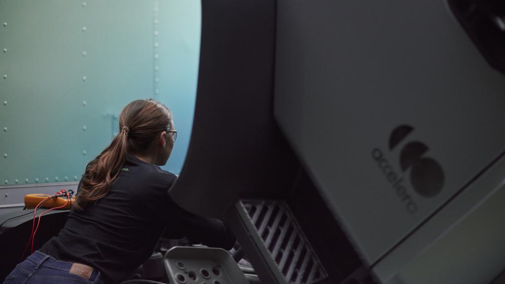 Female technician working under the hood of an Accelera zero-emission truck