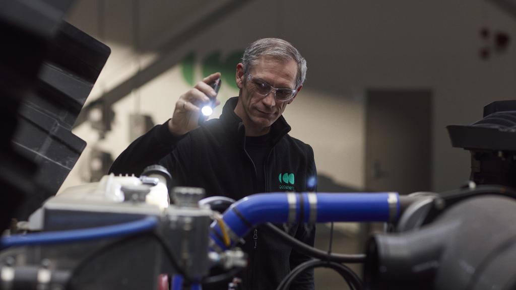 Senior engineer working under the hood of a zero-emissions truck