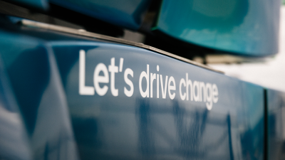 Let's drive change in white lettering on the step up into a zero-emission truck