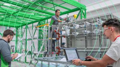 Two men work in factory