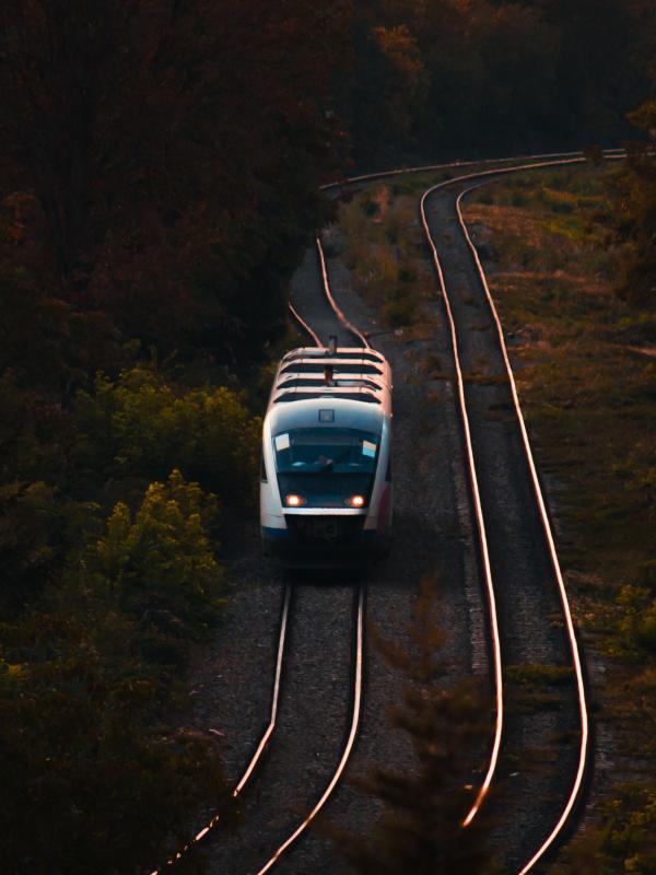 A train on rails during sunset