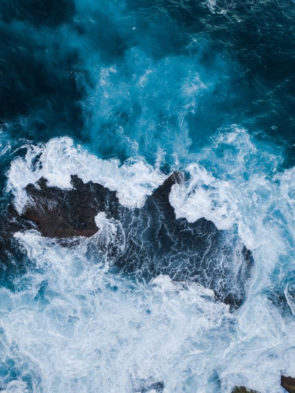 Ocean waves crashing around rocks