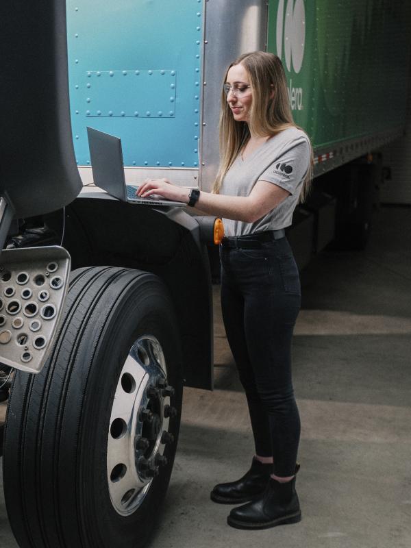 Female engineer working under the hood of an Accelera zero-emission truck