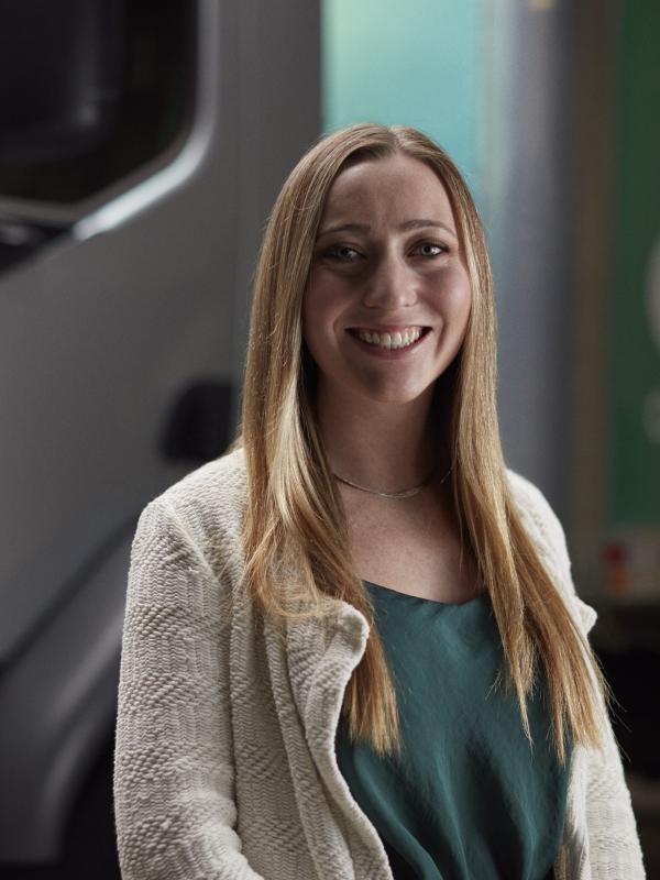 Female engineer standing in front of an Accelera zero-emission truck