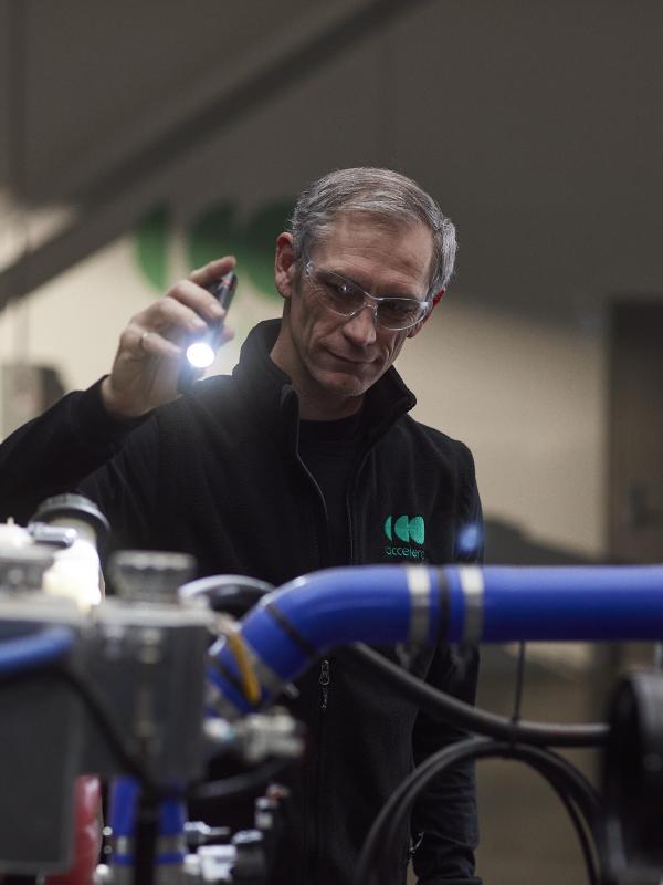 Senior engineer working under the hood of a zero-emissions truck