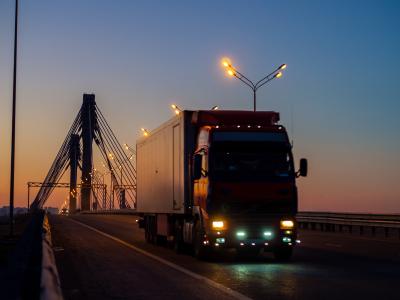 Truck driving on the highway at sunrise