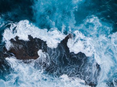 Ocean waves crashing around rocks
