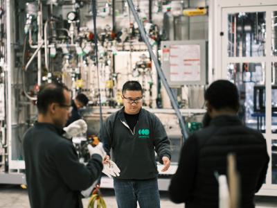 Three men prepping to work on an electrolyzer system