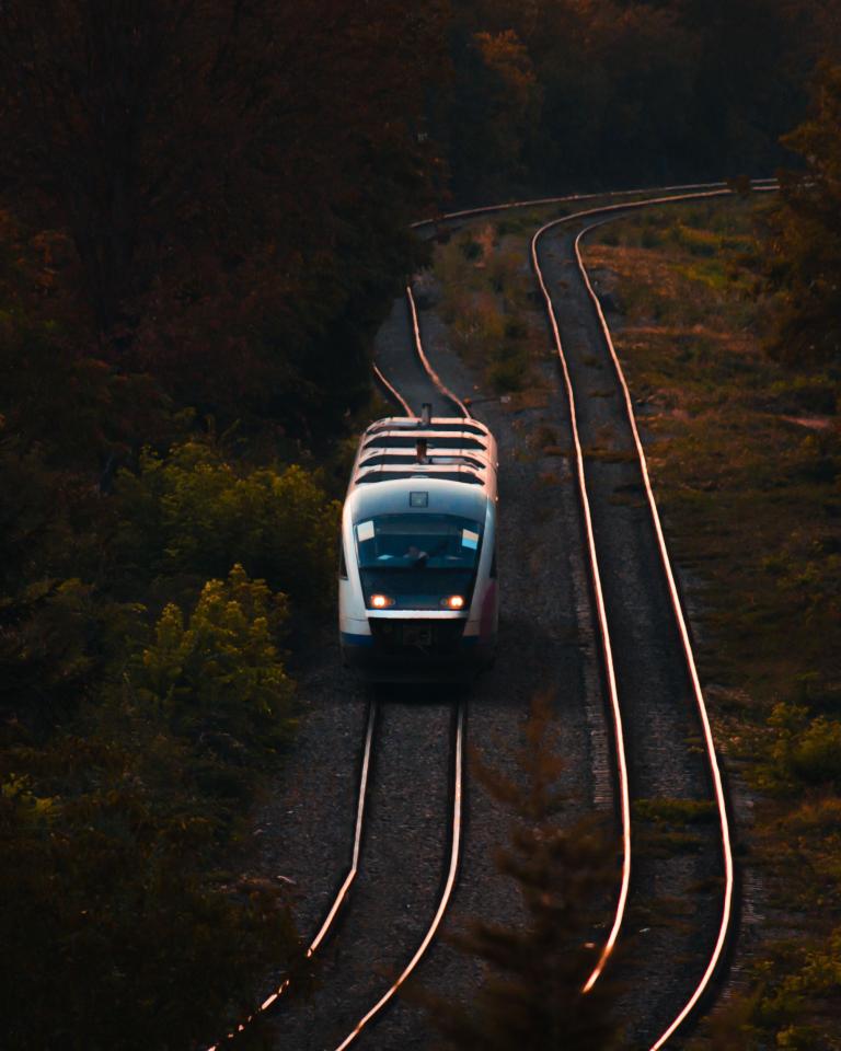 A train on rails during sunset