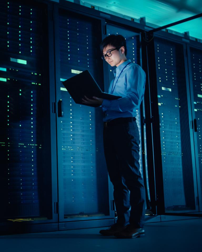 IT technician running maintenance programme in data center