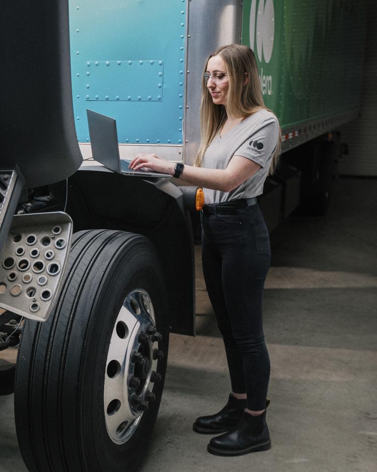 Female engineer working under the hood of an Accelera zero-emission truck