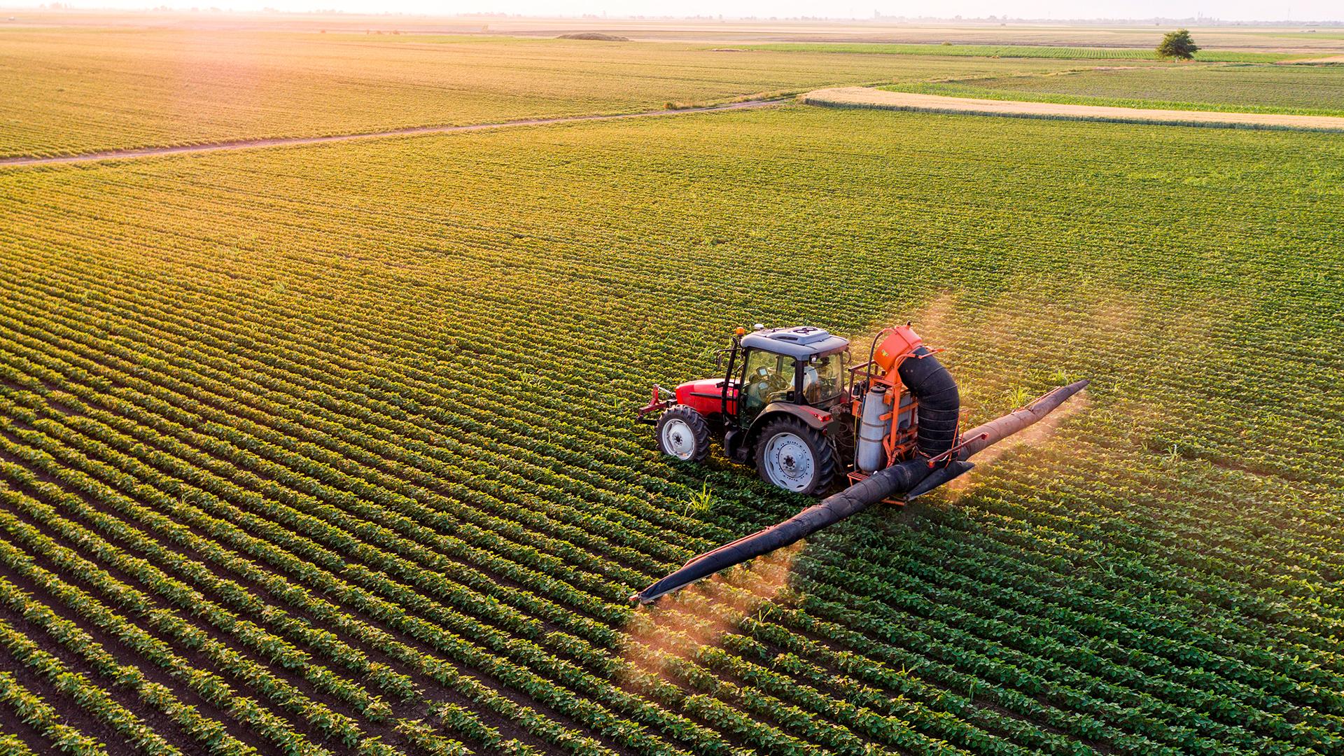 Red tractor in a green field
