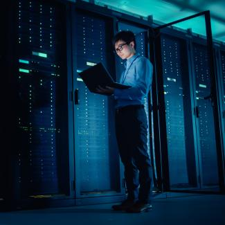 IT technician running maintenance programme in data center